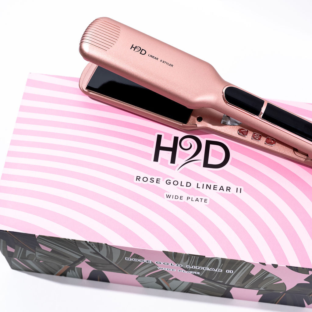 H2D Rose Gold Linear II Wide Plate hair straightener resting on retail packaging box