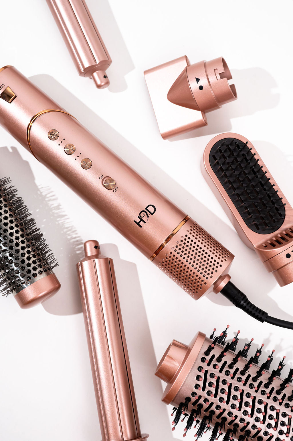 Close-up of H2D 7-in-1 Ultra Styler Rose Gold styling head with round brush and diffuser attachments